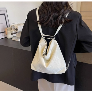 Minimalist beige PU leather backpack tote shown on model back in minimalist setting