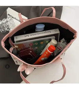 Interior view showing spacious tote bag capacity with books, tablet, and zip pocket