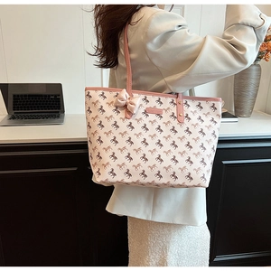 Detail of pink and white tote bag with pony print and decorative bow for commuting
