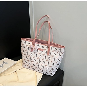 Detail of white tote bag with pink horse print, bow decor and lifestyle props