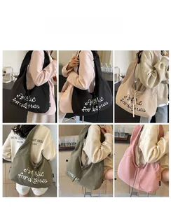 Detail showing the large canvas crossbody bag in black, beige, green, and pink colors