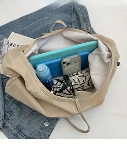 Spacious interior of beige canvas tote bag showing storage for tablet and umbrella