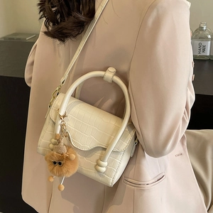 Fashionable cream crocodile pattern crossbody bag with a cute plush lion pendant for women