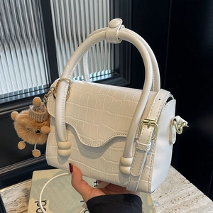 White crocodile texture small crossbody bag with stylish round handles and plush charm