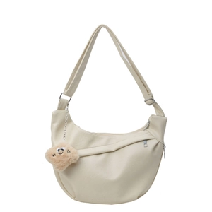 Minimalist cream white crescent shoulder bag with plush smiley charm and wide strap