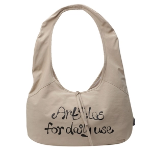 Minimalist beige canvas hobo bag with artistic lettering on a clean white background