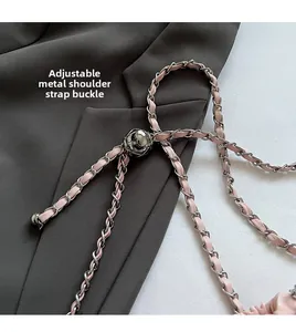Detail of adjustable metal chain strap with pink leather inlay and sphere buckle
