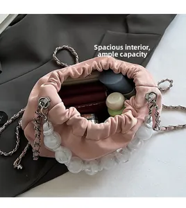 Macro shot of spacious pink bucket bag interior with cosmetics and drawstring detail