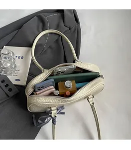 Top view of spacious cream leather boston bag showing large interior storage space