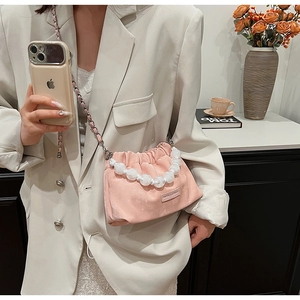 Pink pleated cloud bag featuring oversized white pearl handle and metal chain strap