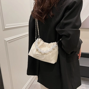 Elegant cream pleated cloud bag with pearl handle and chain strap crossbody style