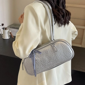 Silver large shoulder bag with unique textured pattern and a blue checkered ribbon bow