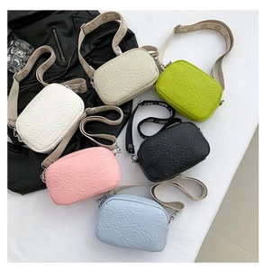 Close-up of small crossbody bags in six colors with elegant rose embossed patterns