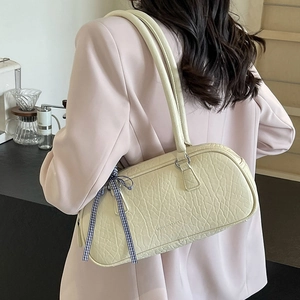 Elegant cream underarm bag with elephant pattern texture and blue plaid ribbon detail