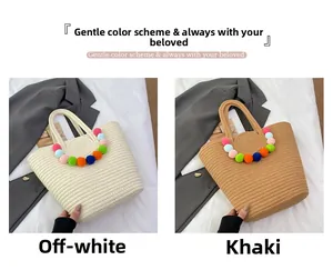 Detail of woven beach tote bags in beige and khaki featuring colorful pompom charms