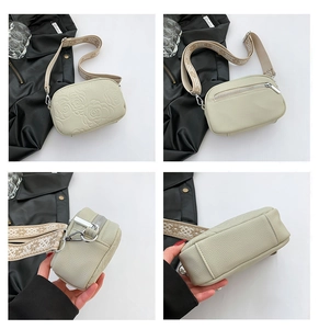 Detail view of beige crossbody bag showing floral embossing and bohemian strap