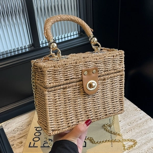 Handwoven straw box bag with top handle and gold chain strap for summer beach vacation