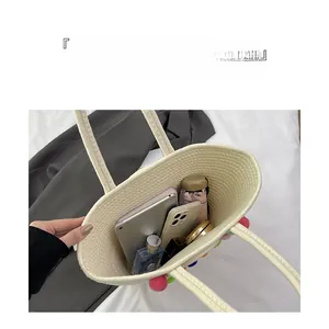 Detailed interior of a beige woven tote bag showing large capacity for essentials