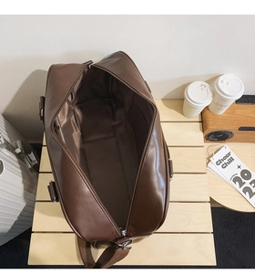 Interior view of large brown faux leather tote bag showing spacious lining and wide zipper