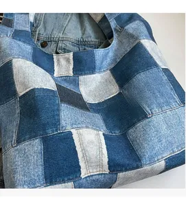 Detailed view of patchwork denim tote bag made with multi-tone blue cotton fabric