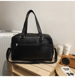 Macro detail of high-quality black matte leather tote bag with sturdy handles and texture
