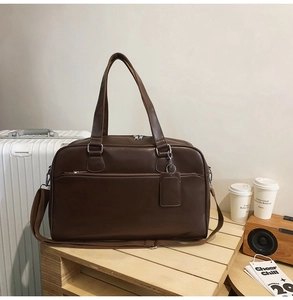 Macro detail of dark brown PU leather tote bag with zipper pocket on wooden tray