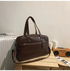 Detailed macro view of dark brown PU leather tote bag texture with silver hardware
