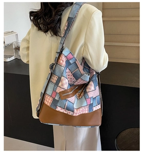 Detailed back view of a patchwork denim and plaid tote bag shown on a model