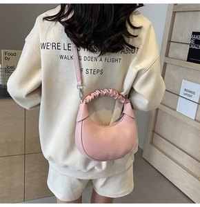 Pink crescent shoulder bag with lychee grain leather and gathered cloud handle detail