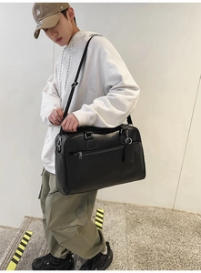 Detail showing high-quality black faux leather texture and silver zipper on tote bag