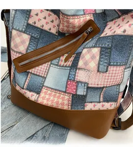 Detail of patchwork denim and floral tote bag with brown faux leather trim and fabric strap