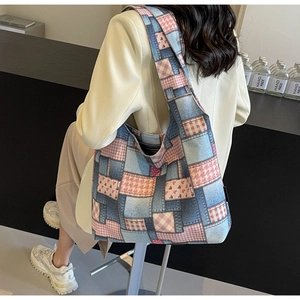 Detail of large denim patchwork tote bag showing spacious capacity and shoulder strap