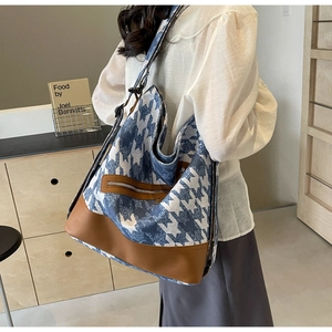 Blue houndstooth tote bag shown in use with large capacity and brown leather details
