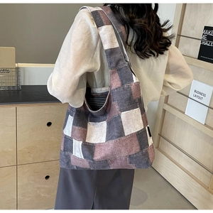 Detail of vintage patchwork canvas tote bag showing large capacity and denim stitching