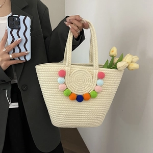 Woven straw beach tote bag with colorful pom-poms and large capacity for summer vacation