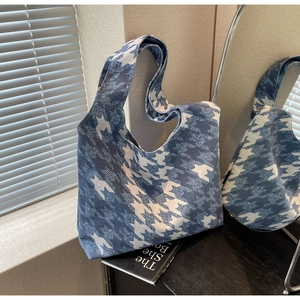 Detail of blue and white houndstooth canvas tote bag with spacious interior and strap