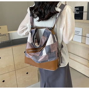 Detailed back view of patchwork canvas backpack with adjustable straps and zipper pocket