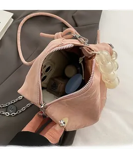 Detail view of pink beaded handbag interior showing large capacity for essentials