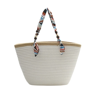 Straw woven tote bag with colorful silk scarf handle and wooden beads for beach vacations