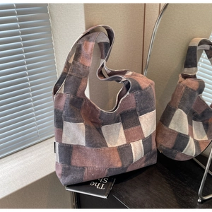 Detail of retro patchwork denim tote bag with high-quality distressed wash fabrics
