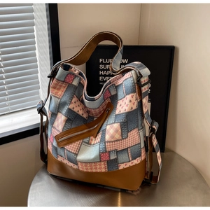 Detail of canvas tote bag with side metal zipper and reinforced leather bottom detail