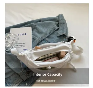 Internal capacity view of white crossbody waist bag holding a phone and wallet