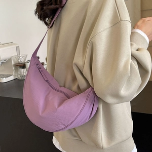 Minimalist purple half-moon canvas shoulder bag styled for daily casual wear