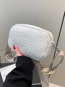 White minimalist square crossbody bag with floral embossing and jacquard strap