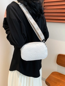 White crossbody bag with rose floral embossing and embroidered wide shoulder strap