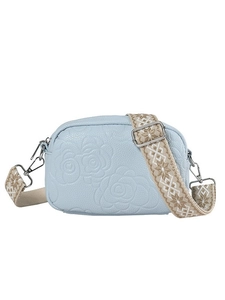 Light blue crossbody bag with embossed rose pattern and colorful woven strap