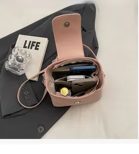 Interior view of the pink bucket bag showing multi-layer storage and daily essentials