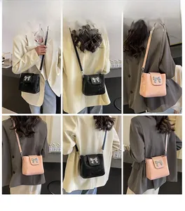 Model lifestyle shots of fashionable bucket bags with metal bow details in black and pink