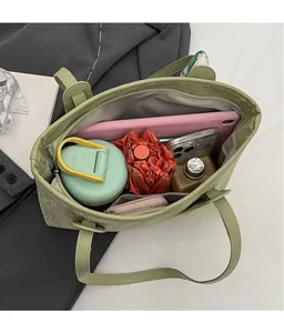 Interior view of large capacity sage green tote bag showing spacious storage compartments