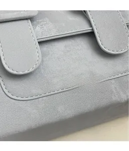 Close-up of light grey cambridge bag showing high-quality twill fabric texture and stitching